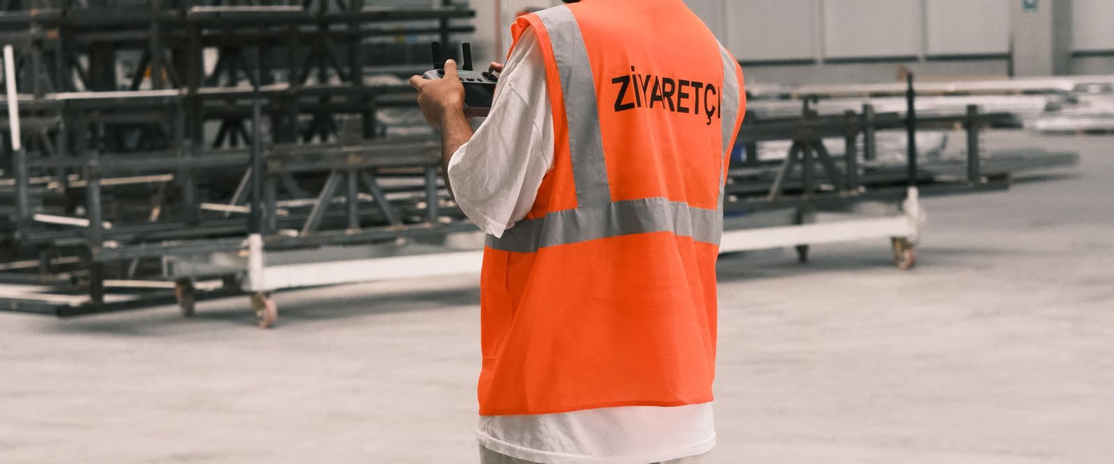 Worker in a safety vest at an industrial site